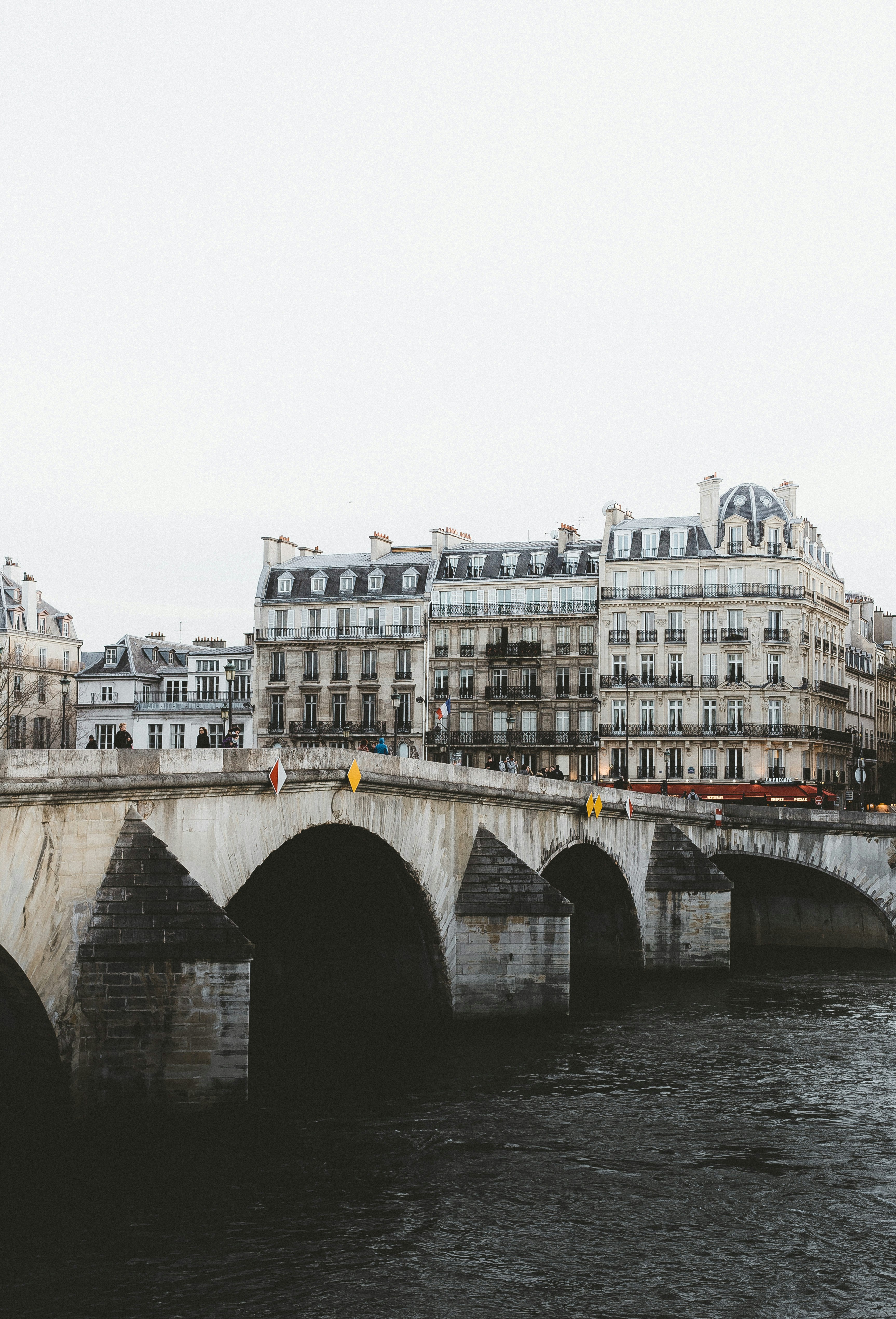 brown concrete bridge over river during daytime